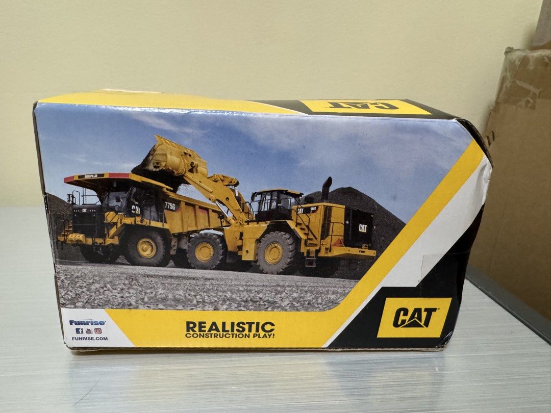 CAT Mini Crew Dump Truck (Category: Vehicle & Diecast Models) located in San Juan City. Submitted by biancaong10 (Listing ID 1425193995, Image 2). Description: CAT Mini Crew Dump Truck toy. It is yellow and black, with large black wheels. The box indicates it is suitable for children aged 2+. The toy is made by Funrise. The box features images of other construction vehicles..