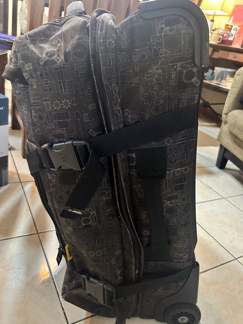 CAT Rolling Luggage (Category: Luggage) located in Pasig City. Submitted by timecheckmanila (Listing ID 1425104428, Image 2). Description: Durable CAT rolling luggage with a unique patterned design. Features multiple compartments and straps for secure packing. Includes a handle and wheels for easy transport. The luggage has a CAT logo on the front. Selling cheap. WYSIWYG.