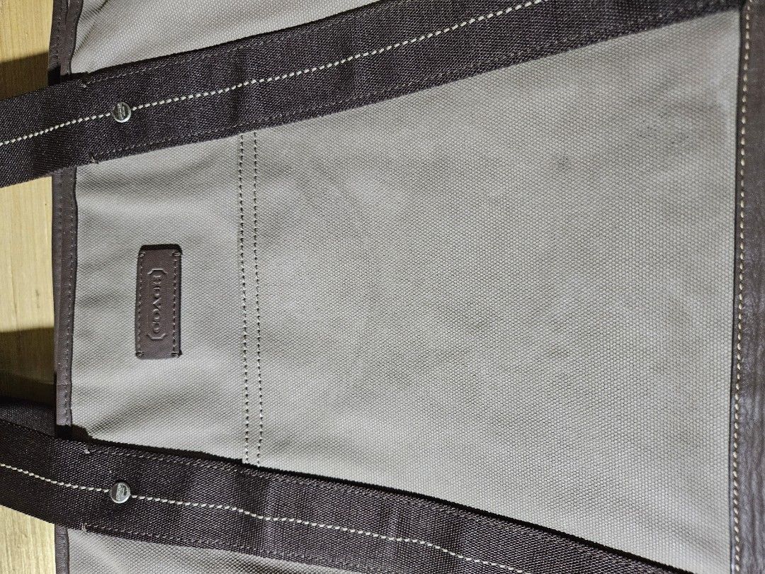 Coach Tote Bag (Category: Luxury Bags & Wallets) located in Valenzuela. Submitted by _myperfectstuff (Listing ID 1425207583, Image 3). Description: Stylish Coach tote bag featuring a grey canvas body with brown leather accents and a vibrant yellow leather base. It has sturdy handles and a spacious interior with a pocket. The bag includes a Coach logo patch. Approximate width is 20 inches. Perfect for everyday use..