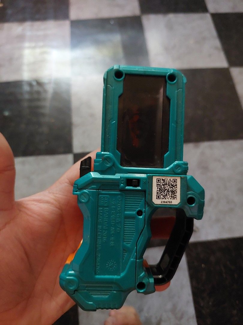 DX Mighty Brothers XX Gashat (Category: Action & Battle Toys) located in Pasay City. Submitted by fhranciscorner (Listing ID 1425195613, Image 2). Description: DX Mighty Brothers XX Gashat. It features an orange and teal color scheme. The item has a detailed design with the Mighty Brothers XX artwork visible. The back of the item has a QR code and some text..