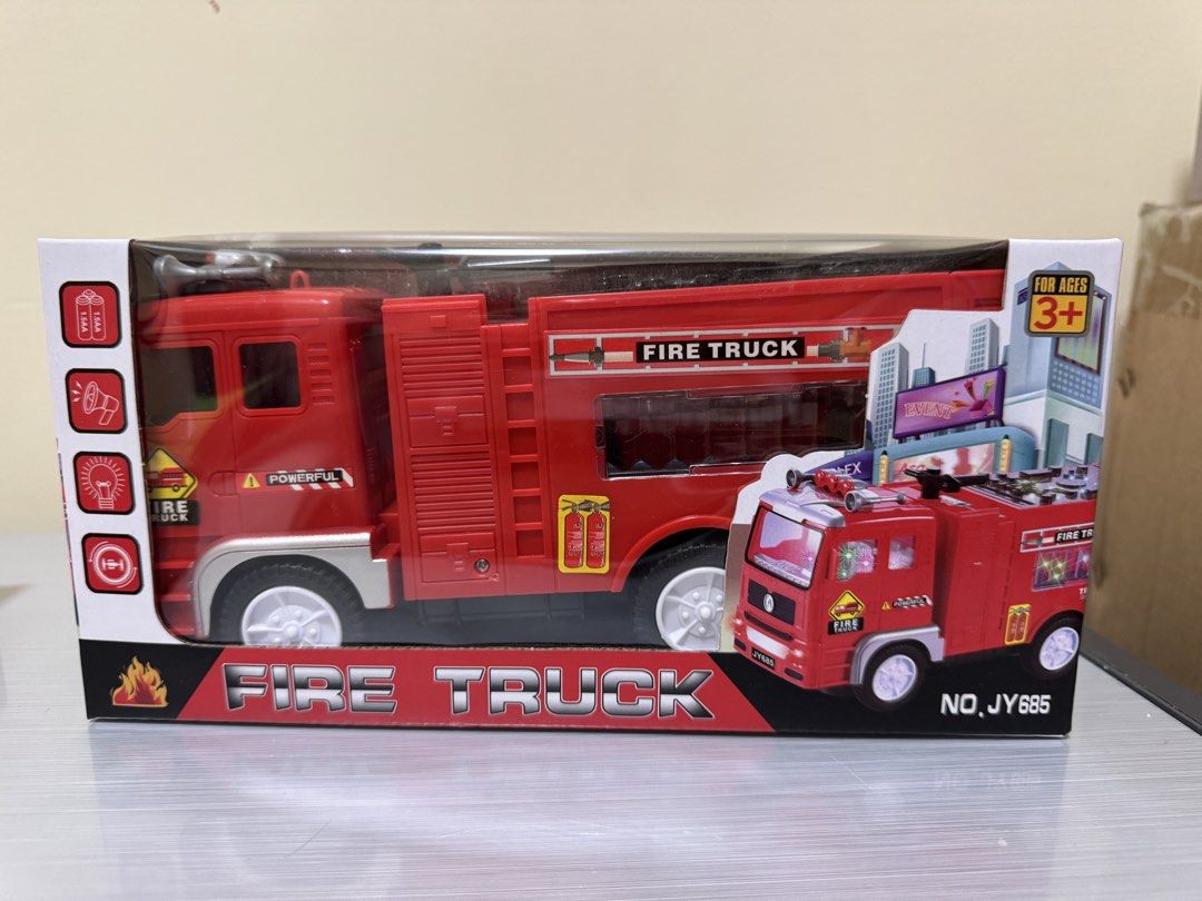 Fire Truck Toy for Ages 3+ (Category: Kids Toys) located in San Juan City. Submitted by biancaong10 (Listing ID 1425193463, Image 1). Description: Red fire truck toy suitable for children aged 3 and above. It features a detailed design with multiple wheels and a ladder. The box indicates it has lights and sounds. The toy is labeled as 'Trailblazer' and includes the words 'Fire Truck' prominently displayed on the packaging..