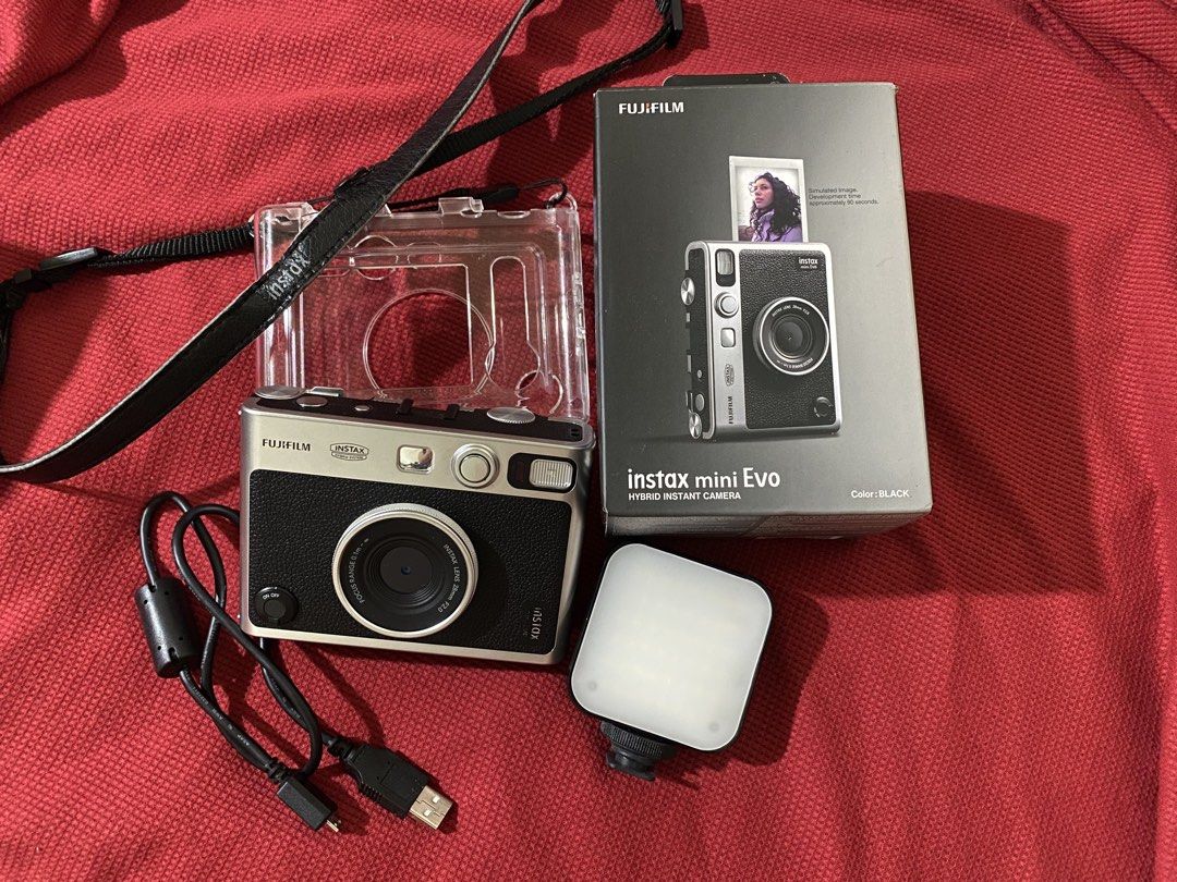 Fujifilm Instax Mini Evo Hybrid Instant Camera (Category: Cameras) located in Cavite. Submitted by zeizeiii_ (Listing ID 1425058455, Image 1). Description: Fujifilm Instax Mini Evo hybrid instant camera in black. Includes the original box, acrylic case, a charging cable, and an external flash. No scratches sa mismong cam. Nasa photos din naman mga sample pic gamit yung cam Slightly Negotiable ❗️RFS: Need Funds ❗️Issue: -yung nasa screen sa 2nd pi