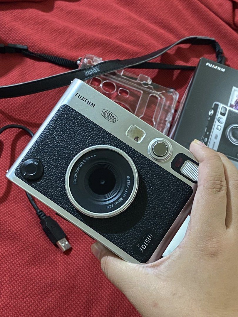 Fujifilm Instax Mini Evo Hybrid Instant Camera (Category: Cameras) located in Cavite. Submitted by zeizeiii_ (Listing ID 1425058455, Image 3). Description: Fujifilm Instax Mini Evo hybrid instant camera in black. Includes the original box, acrylic case, a charging cable, and an external flash. No scratches sa mismong cam. Nasa photos din naman mga sample pic gamit yung cam Slightly Negotiable ❗️RFS: Need Funds ❗️Issue: -yung nasa screen sa 2nd pi