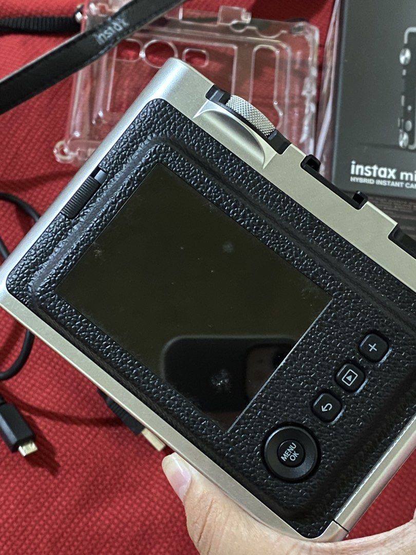 Fujifilm Instax Mini Evo Hybrid Instant Camera (Category: Cameras) located in Cavite. Submitted by zeizeiii_ (Listing ID 1425058455, Image 2). Description: Fujifilm Instax Mini Evo hybrid instant camera in black. Includes the original box, acrylic case, a charging cable, and an external flash. No scratches sa mismong cam. Nasa photos din naman mga sample pic gamit yung cam Slightly Negotiable ❗️RFS: Need Funds ❗️Issue: -yung nasa screen sa 2nd pi