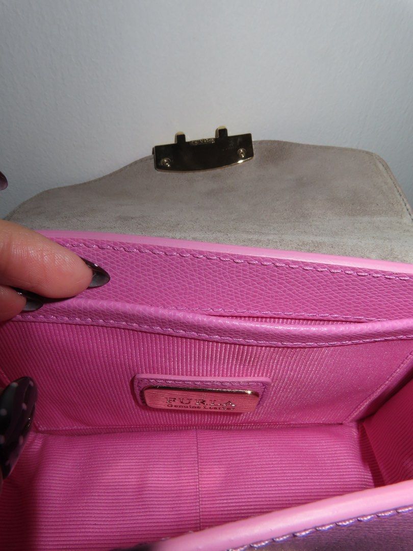 Furla Metropolis Mini Crossbody Bag (Category: Luxury Bags & Wallets) located in Las Pinas. Submitted by katrenperfar (Listing ID 1425220142, Image 3). Description: Authentic Furla Metropolis Mini crossbody bag in a vibrant pink color. Features a gold-tone chain strap and a secure flap closure. The interior includes a small pocket with a Furla label. Comes with a dust bag. The bag's base has protective metal feet. bought in Japan..