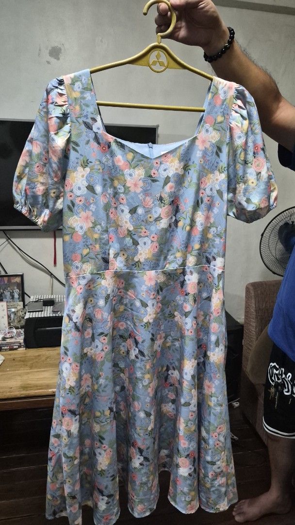 Joni Floral Dress (Category: Dresses) located in Del Monte. Submitted by emem25 (Listing ID 1425201561, Image 1). Description: Beautiful floral dress from Joni. Features a light blue background with a colorful floral pattern. It has puff sleeves and a V-neckline. The dress has a flowy silhouette..