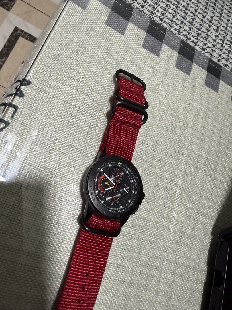 Michael Kors Black Chronograph Watch with Red Strap (Category: Luxury Watches) located in Quezon City. Submitted by TSKOauthcloset (Listing ID 1425248666, Image 3). Description: Stylish Michael Kors watch featuring a black chronograph dial and a striking red strap. The watch has a black case and a detailed dial with multiple sub-dials. The red strap complements the black case, creating a bold contrast..