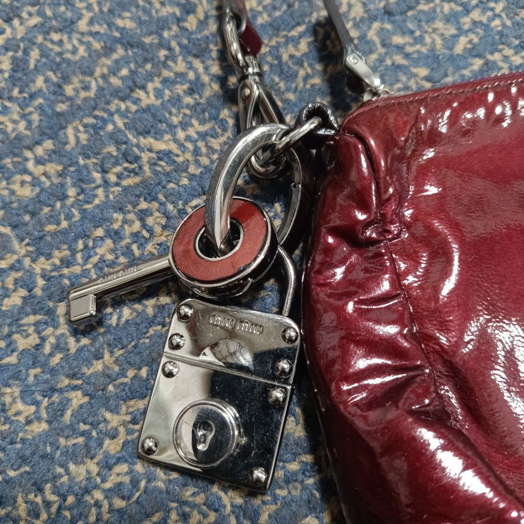 Miu Miu Red Patent Leather Handbag (Category: Luxury Bags & Wallets) located in Angeles City. Submitted by thriftilious.ph (Listing ID 1425218721, Image 2). Description: miu Miu patent leather handbag burgundy, in excellent condition issue check last pics .