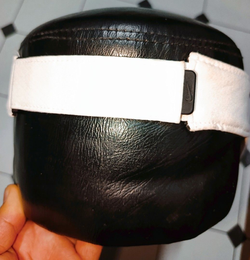 Nike Visor (Category: Caps & Hats) located in Manila. Submitted by cavitethriftitems (Listing ID 1425192699, Image 3). Description: Nike visor with a white brim and black Nike logo. The visor has a black leather-like top and an adjustable white strap. The tag indicates the model number DH1926-100. The brim shows some wear and tear..