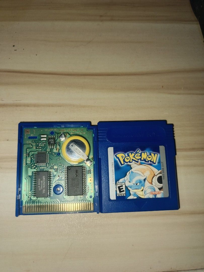 Pokemon Blue Version Game Boy Cartridge (Category: Nintendo) located in Quezon City. Submitted by livebird.27fdd1 (Listing ID 1425213594, Image 1). Description: Pokemon Blue Version cartridge for the Game Boy. Features the iconic Blastoise on the label. The cartridge is blue. The internal components are visible, including the battery and circuit board. This is a classic game for any Pokemon fan..