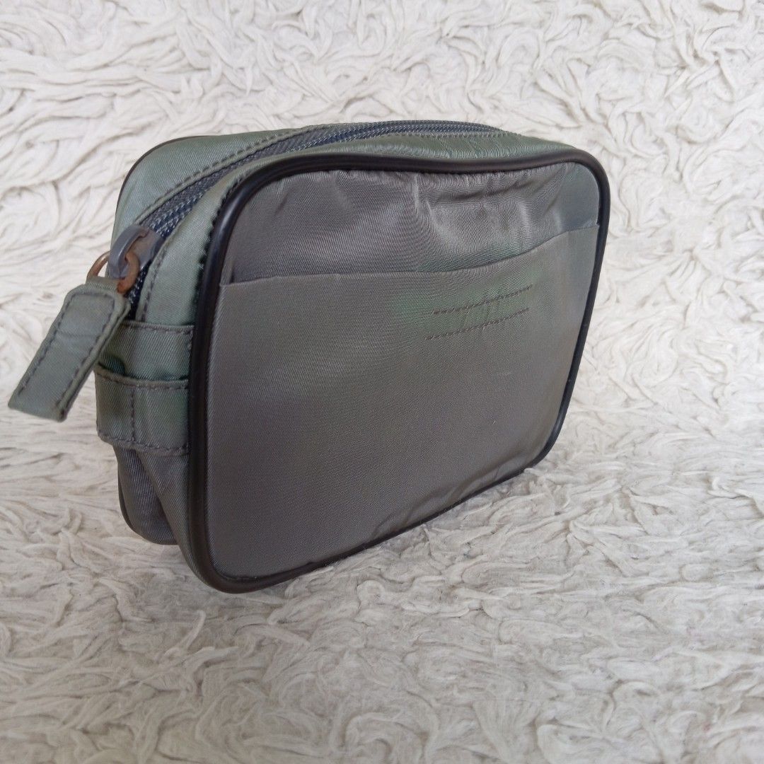 Prada belt bag (Category: Luxury Bags & Wallets) located in Baguio. Submitted by sheren_signatures (Listing ID 1425169323, Image 3). Description: Stylish Prada bag. Features a gray exterior with a black trim and a front pocket. The interior has a Prada Milano label. Perfect for carrying essentials with a touch of luxury. Compact and versatile design..