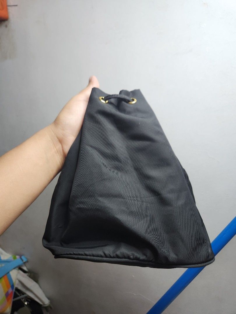 Prada Black Bag (Category: Luxury Bags & Wallets) located in Manila. Submitted by jialyn03310_tree (Listing ID 1425082028, Image 2). Description: Black Prada bag with gold-toned hardware. Features a drawstring closure and a zipper closure. The bag has a Prada Milano logo on the front. The interior has a Prada logo. Includes a detachable strap. Made in Italy. for pouch use only ,pero andito pa lahat ng natangal na part.