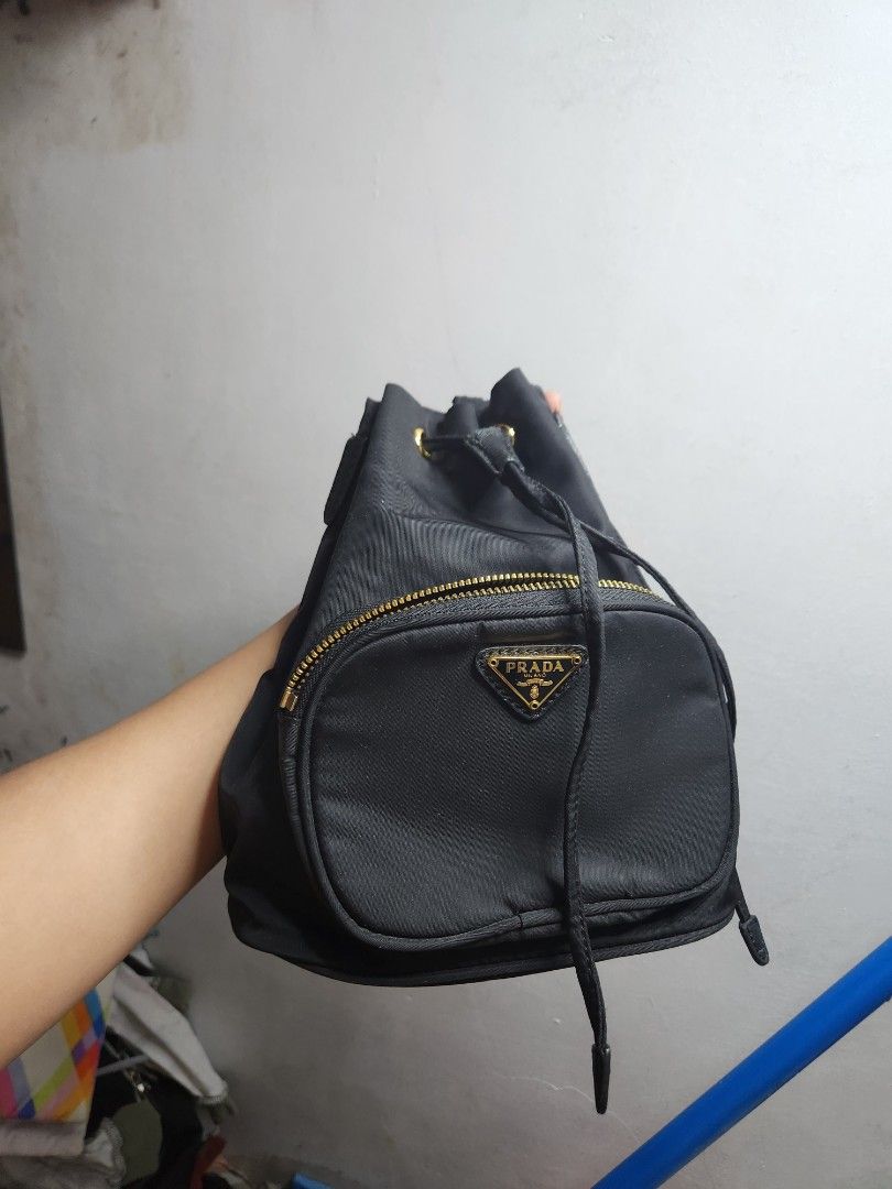 Prada Black Bag (Category: Luxury Bags & Wallets) located in Manila. Submitted by jialyn03310_tree (Listing ID 1425082028, Image 1). Description: Black Prada bag with gold-toned hardware. Features a drawstring closure and a zipper closure. The bag has a Prada Milano logo on the front. The interior has a Prada logo. Includes a detachable strap. Made in Italy. for pouch use only ,pero andito pa lahat ng natangal na part.