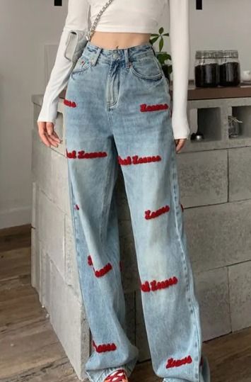 Red Embroidered Wide Leg Denim Jeans (Category: Jeans) located in Cavite. Submitted by cvshops (Listing ID 1425206599, Image 1). Description: 24-26 with belt slot Sobrang ganda ng fitting 39-40 length 399-450+ price online Light wash denim jeans with red embroidered text. Features a wide leg design. The jeans have a high waist and a classic style. The red embroidery is visible on the front and back of the jeans. These jeans are a stylish and comf