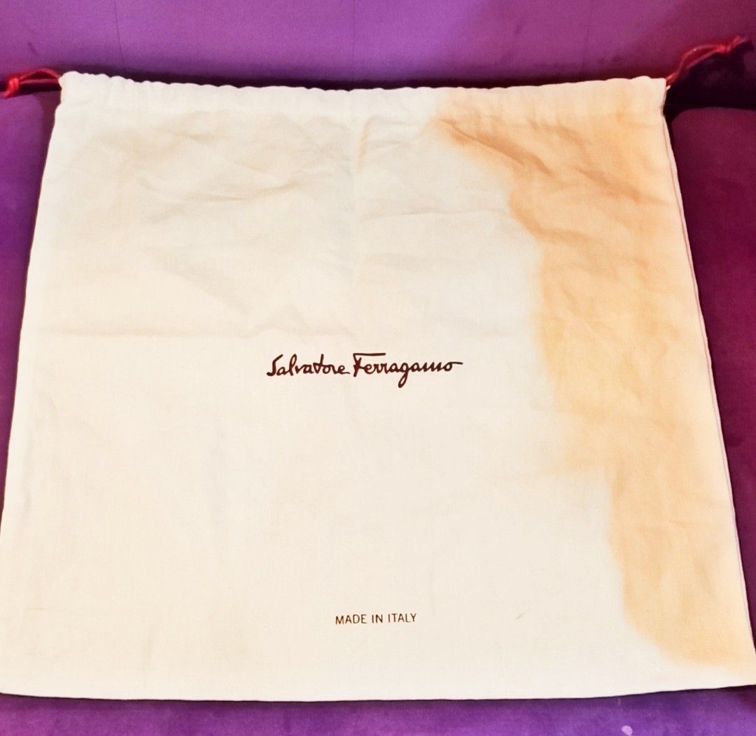 Salvatore Ferragamo Dust Bag (Category: Luxury Bags & Wallets) located in Cabanatuan. Submitted by miss.maia (Listing ID 1425236186, Image 3). Description: Authentic Salvatore Ferragamo dust bag. Made in Italy. Features the Salvatore Ferragamo logo in red. The bag is white with a red drawstring closure. The tag indicates it is made of 100% cotton..