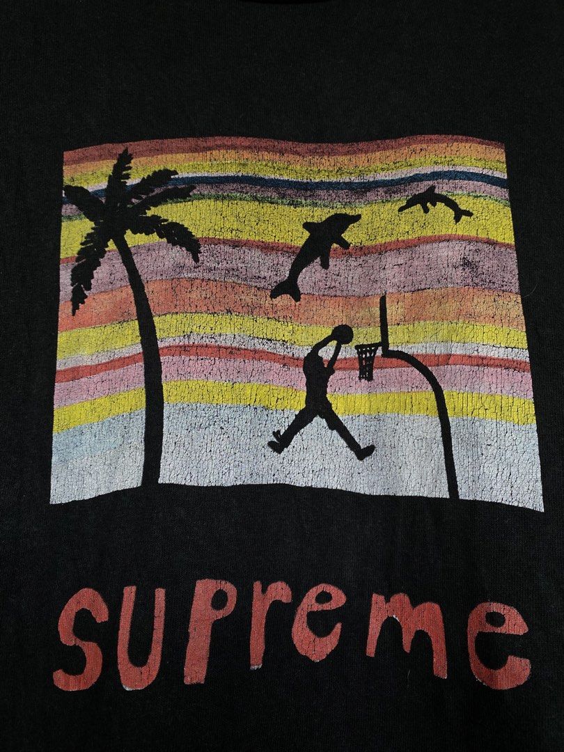 Supreme Basketball Graphic Tee XL (Category: Tshirts & Polo Shirts ) located in Manaoag. Submitted by mangthrifttayo (Listing ID 1425059014, Image 2). Description: Black Supreme t-shirt featuring a basketball graphic on the front. The graphic includes a palm tree, dolphins, and a basketball player. The shirt is size XL and made of 100% cotton. The Supreme logo is visible on the tag..