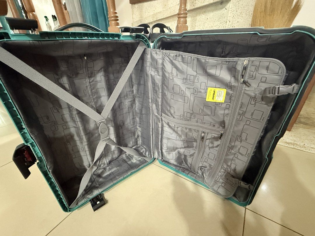 Urban Luggage Teal Suitcase (Category: Luggage) located in San Pablo. Submitted by dtanne (Listing ID 1425194929, Image 2). Description: Teal Urban suitcase with a retractable handle and wheels. The interior features a gray lining with multiple compartments and straps to secure belongings. It has a handle on top and a lock mechanism. The suitcase has the Urban logo on the front..