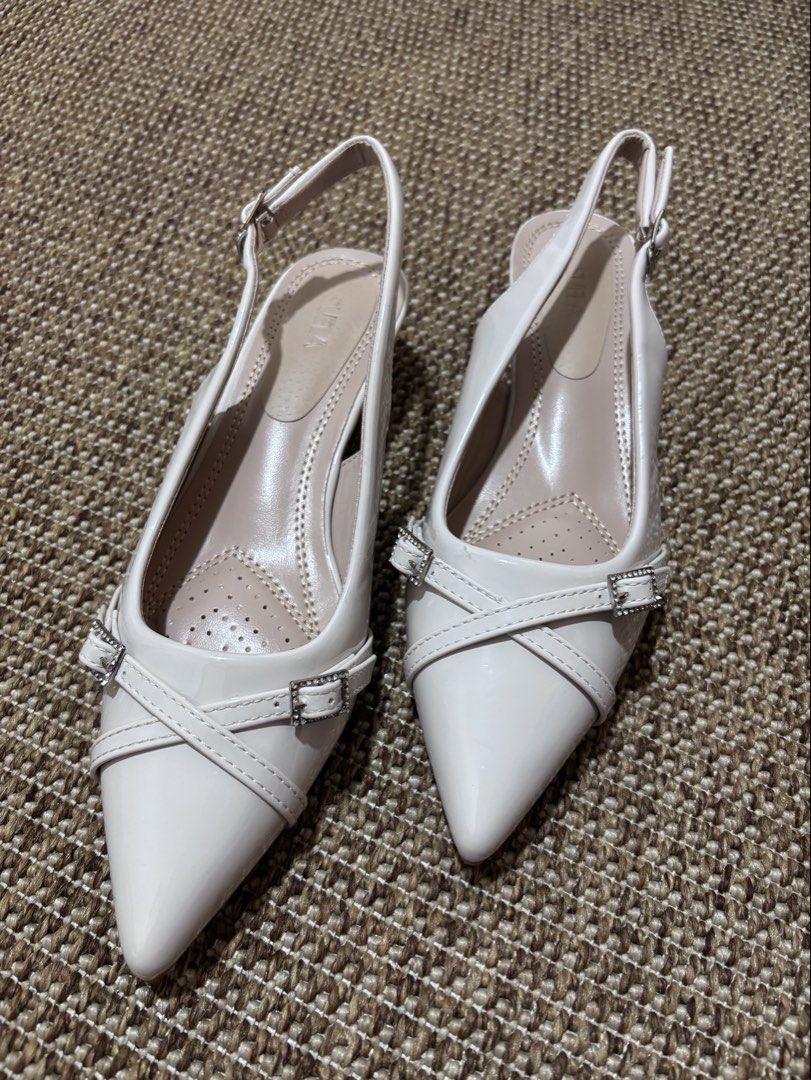 White Slingback Heels Size 38 (Category: Heels) located in Caloocan City. Submitted by stuff_shop (Listing ID 1425068303, Image 2). Description: Elegant white slingback heels with pointed toes. Features a small heel and buckle detailing. The size is 38. Perfect for adding a touch of sophistication to any outfit. The heels have a comfortable insole design. Ideal for both casual and semi-formal occasions..