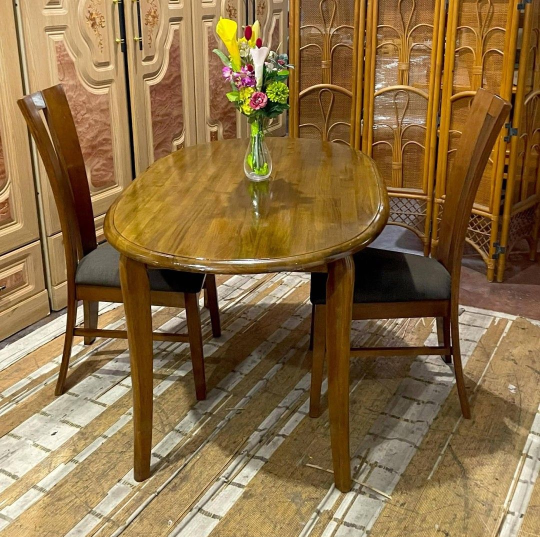 Wooden Dining Table with 2 Chairs (Category: Tables & Sets) located in Manila. Submitted by wiseocean.25b393 (Listing ID 1425082073, Image 2). Description: Elegant wooden dining set perfect for small spaces. Includes a table and two chairs. The table has a smooth, oval surface. Chair dimensions: H-17/38 inches, L-19 inches, W-18 inches. Table dimensions: H-27.5 inches, L-52 inches, W-32 inches. The set is made of wood with a warm, natural finish.