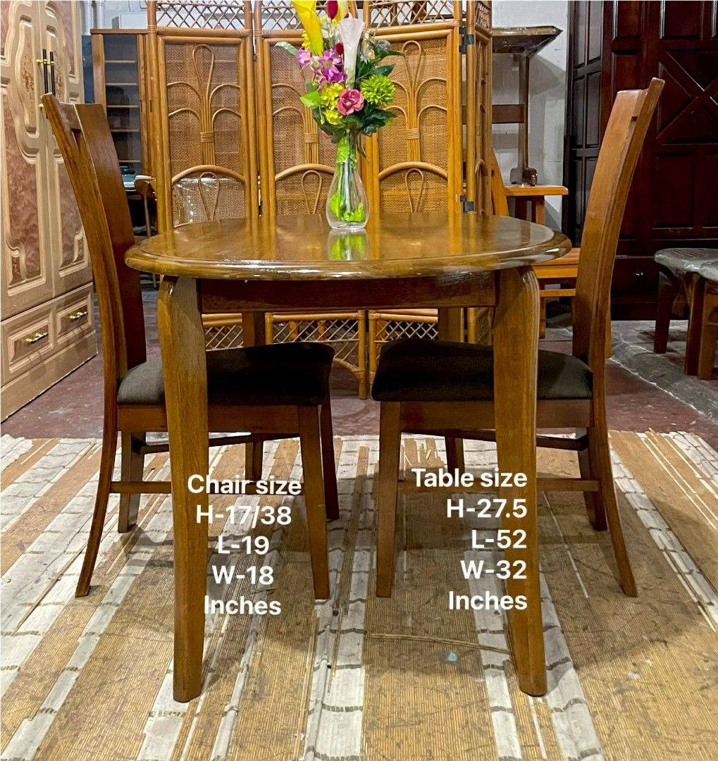 Wooden Dining Table with 2 Chairs (Category: Tables & Sets) located in Manila. Submitted by wiseocean.25b393 (Listing ID 1425082073, Image 1). Description: Elegant wooden dining set perfect for small spaces. Includes a table and two chairs. The table has a smooth, oval surface. Chair dimensions: H-17/38 inches, L-19 inches, W-18 inches. Table dimensions: H-27.5 inches, L-52 inches, W-32 inches. The set is made of wood with a warm, natural finish.