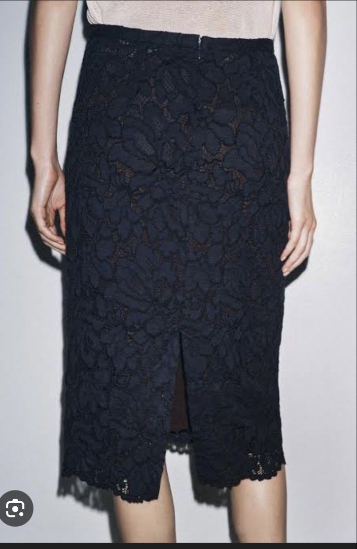 Zara Lace Midi Skirt (Category: Skirts) located in Quezon City. Submitted by twinklestyle (Listing ID 1425216272, Image 2). Description: Elegant Zara midi skirt in a beautiful navy lace design. Features a flattering silhouette with a slit at the back for ease of movement. Perfect for both casual and semi-formal occasions. The skirt has a scalloped hemline, adding a touch of sophistication. A versatile piece that can be dressed up or down. Retails