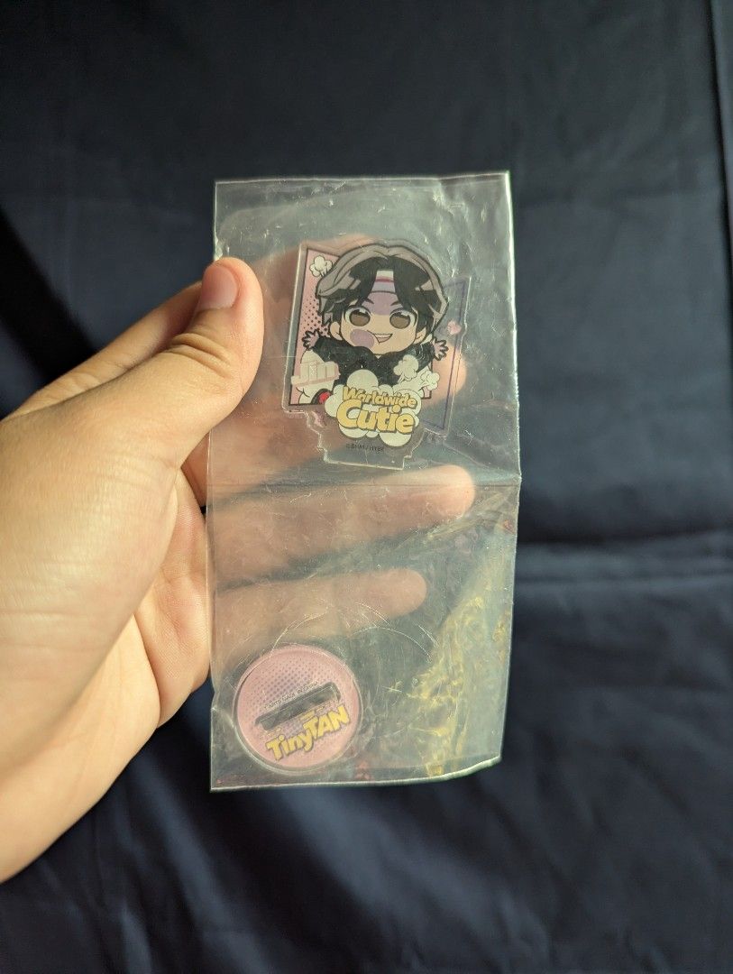 [𝐊𝐏𝐎𝐏] BTS Jin TinyTAN Dynamite Acrylic Standee (Category: K-Wave Merchandise) located in Tandag. Submitted by mooncrate (Listing ID 1425441834, Image 1). Description: Listing features a TinyTAN Dynamite acrylic standee. It comes with a TinyTAN pin. The standee features a character with black hair and a headband. The standee is in its original packaging. The pin is pink with the TinyTAN logo..