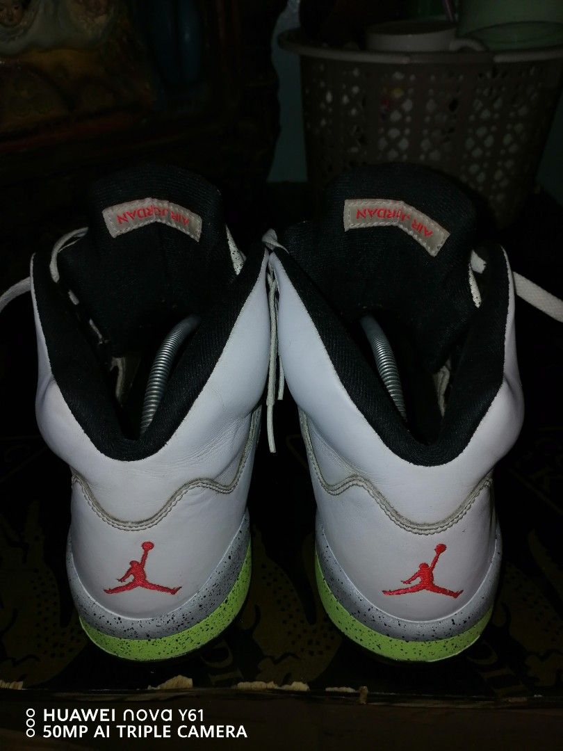 Air Jordan 5 "Poison Green" (Category: Sneakers) located in Valenzuela. Submitted by bryn30 (Listing ID 1425262174, Image 3). Description: Air Jordan 5 Retro sneakers in white with red and black accents. Features the iconic Jumpman logo on the tongue and heel. The sole has a mix of colors including green, black, and red. The shoes have white laces and a speckled design on the tongue area..
