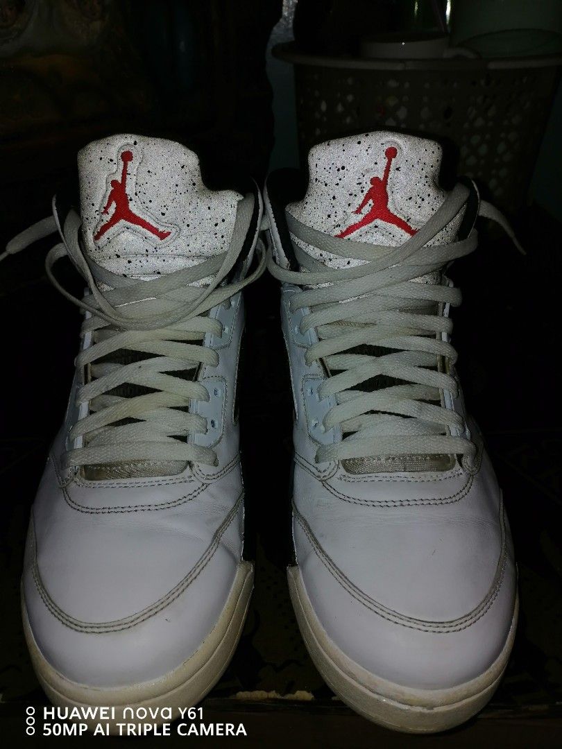 Air Jordan 5 "Poison Green" (Category: Sneakers) located in Valenzuela. Submitted by bryn30 (Listing ID 1425262174, Image 2). Description: Air Jordan 5 Retro sneakers in white with red and black accents. Features the iconic Jumpman logo on the tongue and heel. The sole has a mix of colors including green, black, and red. The shoes have white laces and a speckled design on the tongue area..
