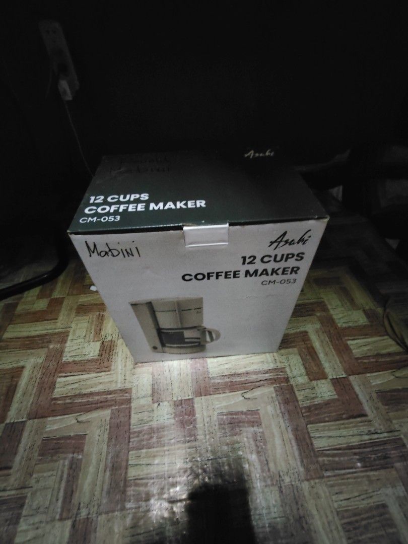 Asahi 12 Cups Coffee Maker CM-053 (Category: Coffee Machines & Makers) located in Manila. Submitted by ronysabela53624 (Listing ID 1425255408, Image 1). Description: Asahi 12 Cups Coffee Maker. Model CM-053. This coffee maker is designed to brew up to 12 cups of coffee. The box shows the coffee maker's design. Perfect for brewing coffee at home or in the office..
