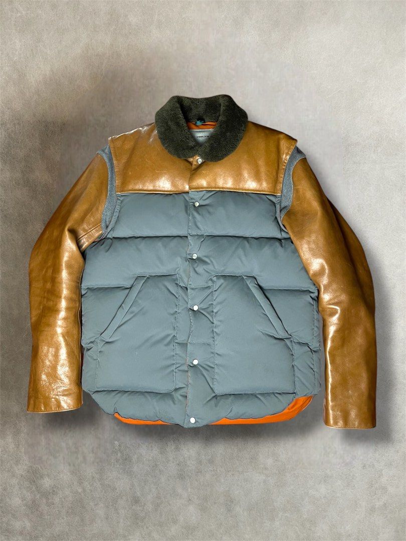 AW2012 Undercover leather sleeve down feather puffer jacket (Category: Activewear) located in Manila. Submitted by killzarchival (Listing ID 1425272176, Image 1). Description: AW2012 Undercover leather sleeve down feather puffer jacket *Condi:7/10 *Good condition with overall normal visible sign of using Size:3 Pit to pit:22 Length:27 Shoulder:17.5 Sleeve:25.5 Hem:22 .
