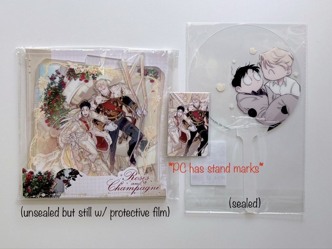 [BL MERCH] Roses and Champagne Standee Set (Category: Designer & Blind Box Toys) located in Taguig. Submitted by hello___world (Listing ID 1425374252, Image 2). Description: Standee - unsealed but still w/ protective film Photocard - stand marks visible under the light Clear Fan - sealed SOLD x sensitive buyers | no rush shipping .