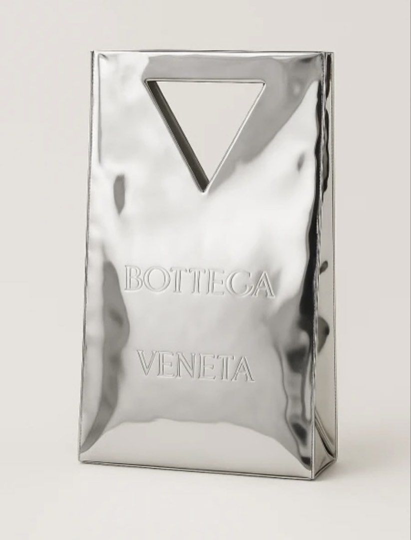 BOTTEGA VENETA Silver Shopper Gift Bag (Category: Luxury Bags & Wallets) located in Quezon City. Submitted by wasmynnowurs (Listing ID 1425409308, Image 1). Description: This item is a gift from the brand and was never available for purchase hence little information available online. Material is acetate. Small imperfection (Photo 4) on one side which is hardly visible / only visible depending on angle. Photo 5 is the same spot in a different angl