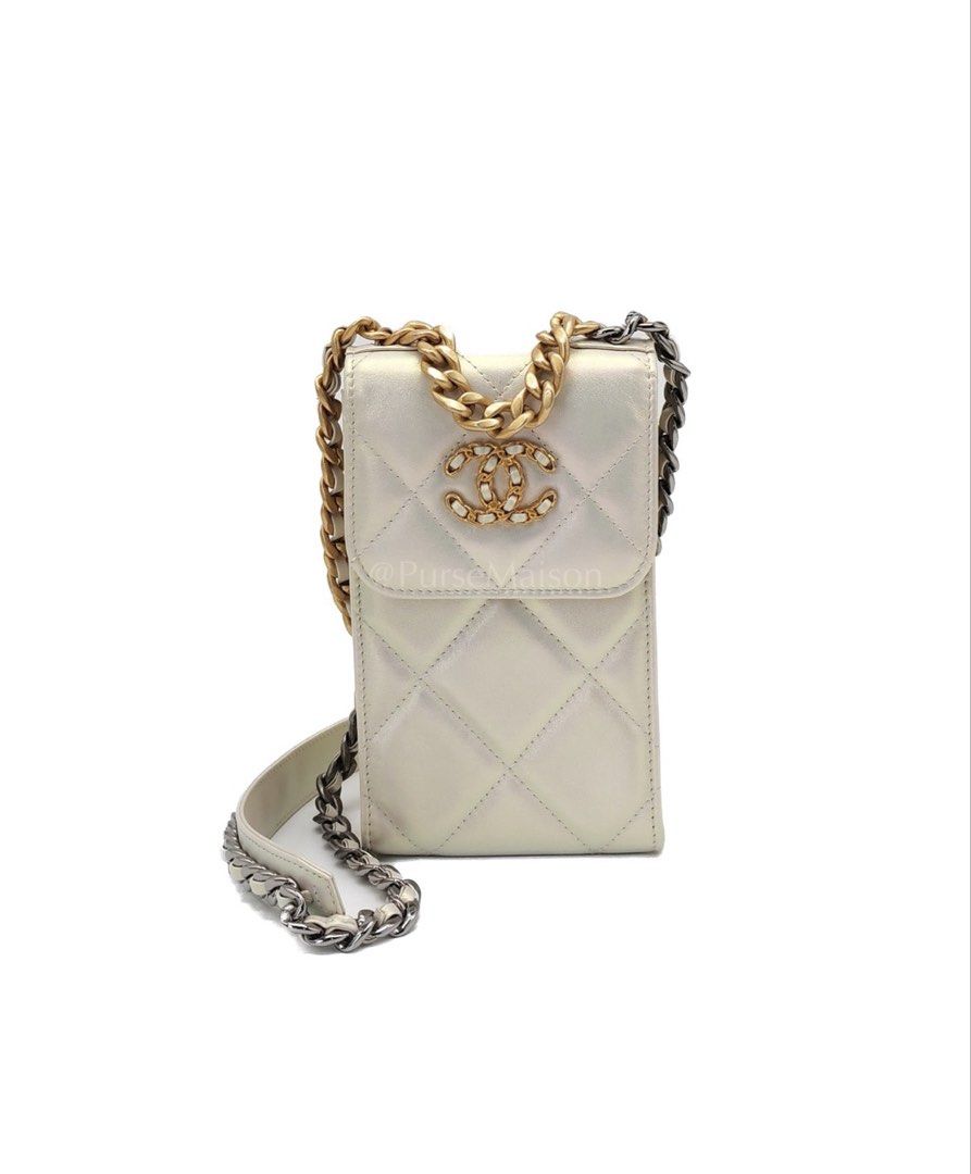 Chanel 19 Phone Holder Bag (Category: Luxury Bags & Wallets) located in Taguig. Submitted by pursemaison (Listing ID 1425341465, Image 1). Description: Chanel 19 Phone Holder Quilted Iridescent Lambskin Leather in Mix Hardware (Series 31) Price: Php 137,900.00 Condition: Excellent (9/10) Exterior: Minor press marks, mild marks on the leather and loose stitch. Interior: Mild signs of usage. Hardware: Minor oxidation on cc logo. Inclusions: Dust Ba