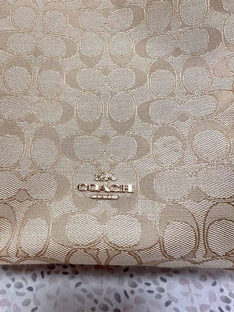 Coach Jacquard Dufflette Bag (Category: Luxury Bags & Wallets) located in Malolos. Submitted by layntev (Listing ID 1425309491, Image 2). Description: Coach - Beige & Cream “Jacquard Dufflette” Bag Stay polished and prepared on-the-go with the Coach “Jacquard Dufflette” Bag. The custom-woven jacquard and smooth leather trim exude luxury, while the gold-tone hardware adds a touch of elegance. The versatile beige and cream color scheme makes this s