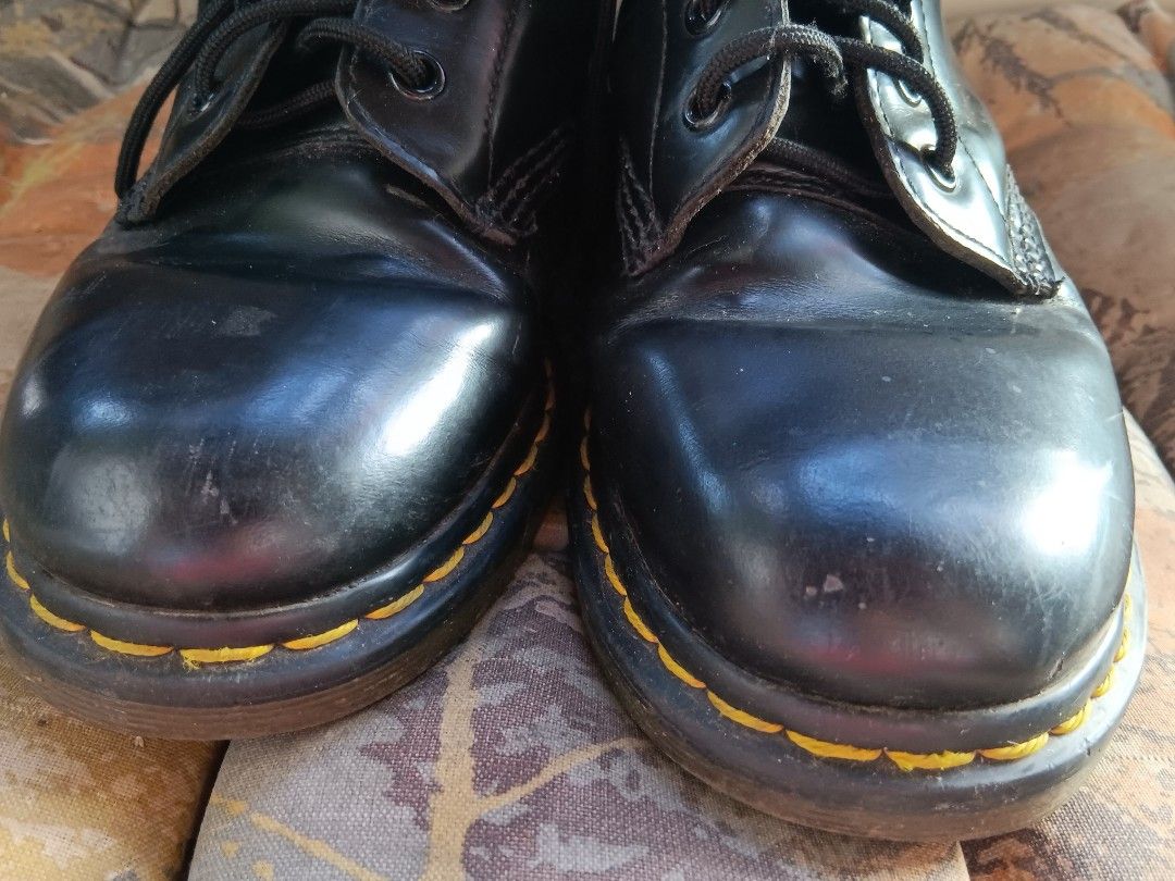 Dr. Martens Black Boots (Category: Boots) located in Manila. Submitted by declutteraf (Listing ID 1425336631, Image 3). Description: Negotiable Classic Dr. Martens boots in black. Features the iconic yellow stitching and air-cushioned sole. The boots have a lace-up design and the Dr. Martens logo is visible on the heel tab. The boots appear to be well-maintained..