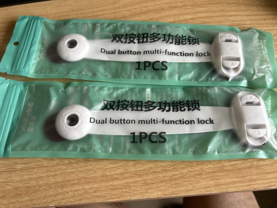 Dual Button Multi-Function Safety Locks (Category: Safety Gates, Locks & Protectors) located in Singapore. Submitted by chubbypies (Listing ID 1425331994, Image 1). Description: Brand new dual button multi-function safety locks. Each pack contains 1 piece. Easy to install and use. Perfect for childproofing your home. Provides added safety for cabinets, drawers, and appliances..
