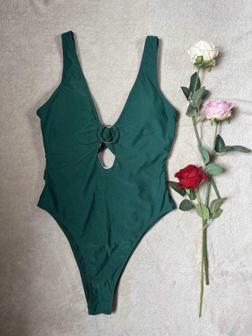 Emerald Green One-Piece Swimsuit (Category: Bikinis & Swimsuits) located in Cabuyao City. Submitted by ririty (Listing ID 1425297868, Image 1). Description: Emerald green one-piece swimsuit features a plunging neckline with a ring detail. It has a high-cut leg design. It's a stylish choice for the beach or pool..