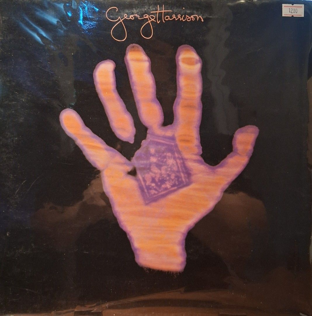 George Harrison - George Harrison Vinyl Record (Category: Vinyls) located in Quezon City. Submitted by pooh_laa (Listing ID 1425338318, Image 1). Description: Original vinyl record by George Harrison. Features the album cover art with a hand holding a purple square. The record is still in its original plastic wrapping. The album title and artist's name are visible on the cover. A price tag is also visible on the top right corner..