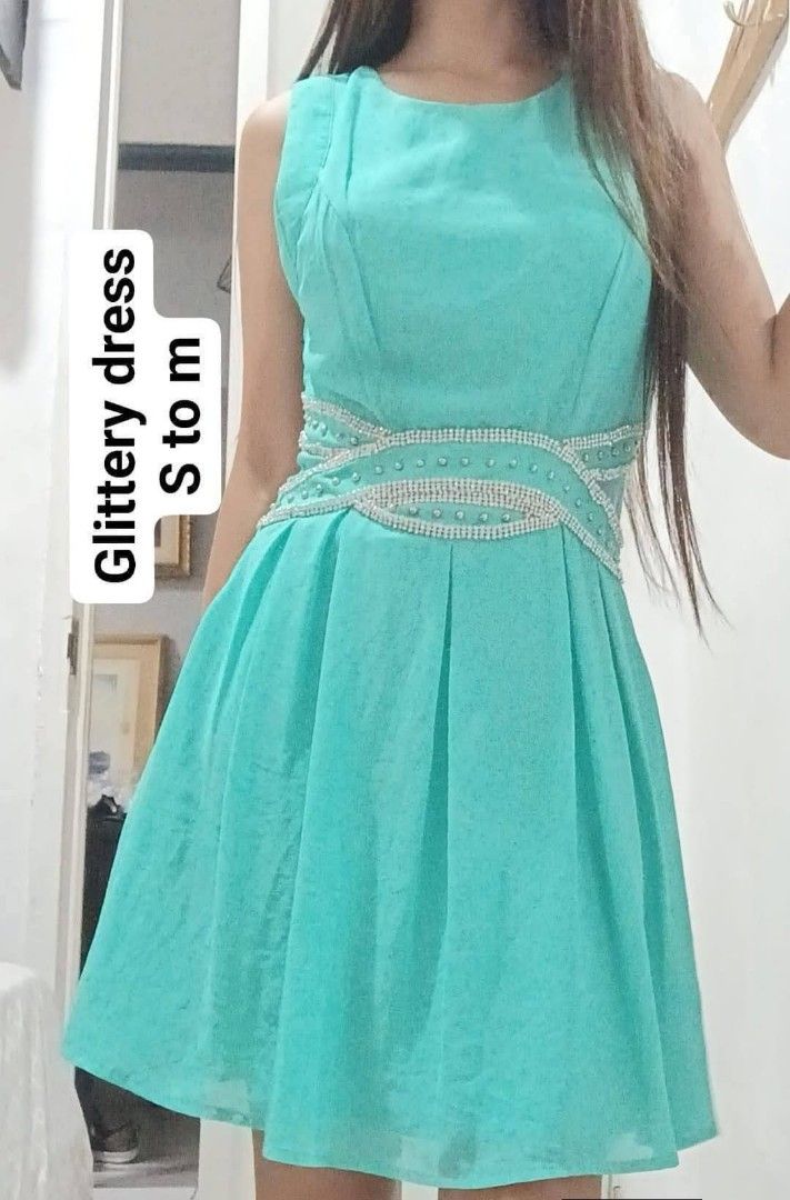 Glittery Dress S to M (Category: Dresses) located in Carmona. Submitted by mickelrein (Listing ID 1425267449, Image 1). Description: Elegant sleeveless dress in a vibrant turquoise color. Features a fitted waistline embellished with sparkling details. The dress has a pleated skirt that flows gracefully. Suitable for various occasions, offering a chic and stylish look. fits s to m.