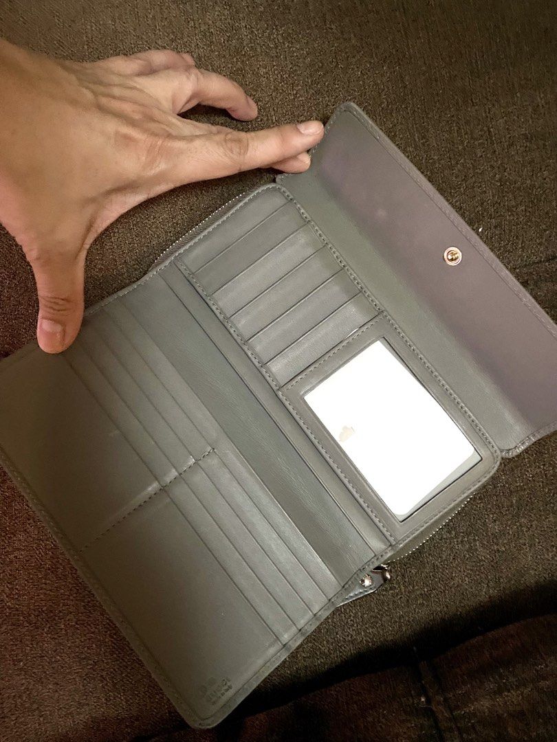 ORIGINAL -Gucci Microguccissima Zip Around Wallet (Category: Luxury Bags & Wallets) located in Manila. Submitted by ina.manila (Listing ID 1425415546, Image 3). Description: - Authentic Gucci wallet - Zip-around closure - Textured microguccissima leather - Neutral gray color - Multiple card slots - Bill compartment - Zippered coin pocket - Interior mirror - Gold-toned hardware - Snap closure.