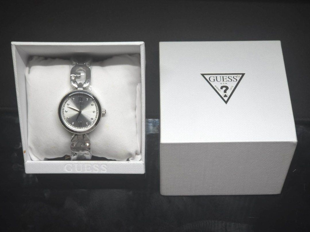 Guess Women's Watch (Category: Women's Watches) located in Quezon City. Submitted by gofundbea (Listing ID 1425371584, Image 1). Description: Elegant GUESS USA Empower 30mm women's watch. Features a silver dial with crystal accents and a stainless steel bracelet. Comes with its original box. The watch has a round face with Roman numeral and stick hour markers. A stylish accessory for everyday wear. Used thrice only!! Like new condition..