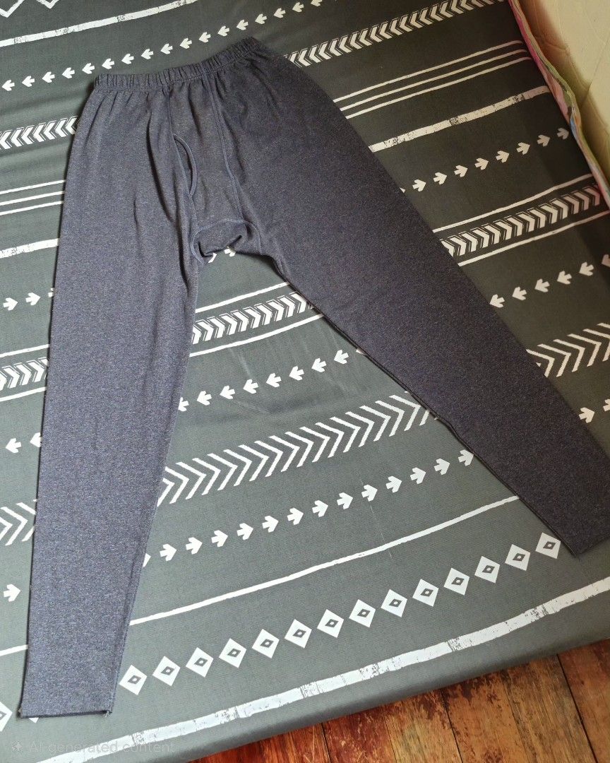 Heattech Long Sleeve Shirt and Pants Set (Category: Activewear) located in Paranaque City. Submitted by nieshaprelovedshop (Listing ID 1425318948, Image 2). Description: Thermal set includes a long-sleeved shirt and pants. The shirt has a crew neck and a red tag. The pants have an elastic waistband. Both pieces are a solid gray color. This set is suitable for layering or wearing on its own. *USED ONCE.
