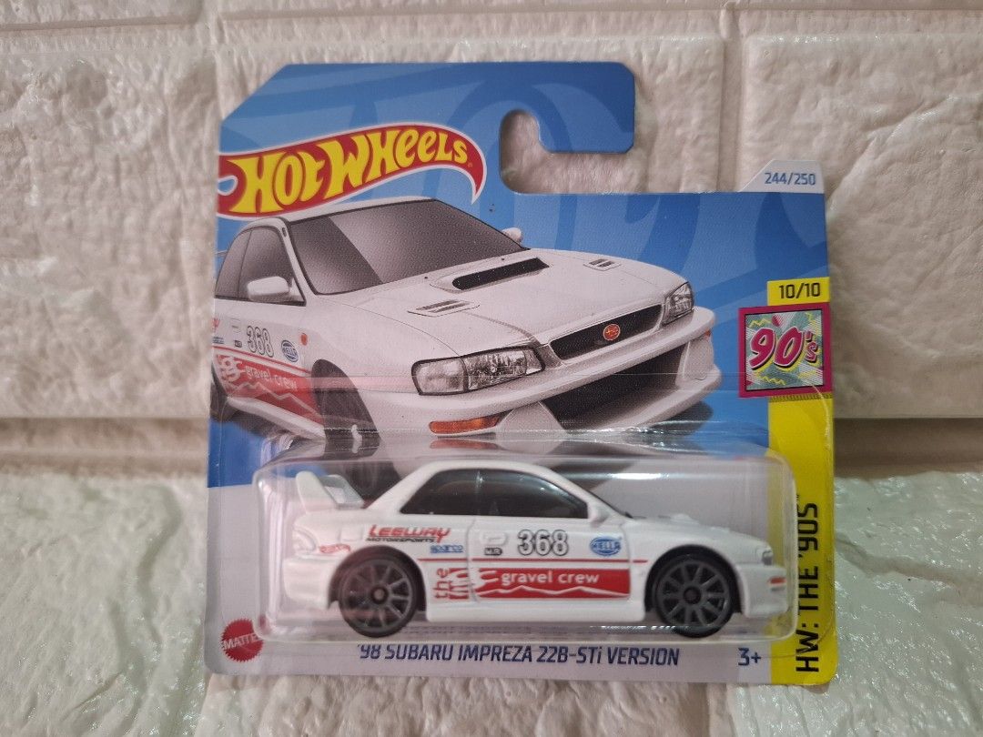 Hot Wheels '98 Subaru Impreza 22B-STI Version (Category: Vehicle & Diecast Models) located in Narvacan. Submitted by jigger85_2ndaccount (Listing ID 1425252380, Image 1). Description: Hot Wheels diecast car features a '98 Subaru Impreza 22B-STI Version. It is part of the HW: The '90s series and is number 10/10 in the set. The car has a white body with red and blue graphics, including the number 368 and "gravel crew" text. It is a 244/250 release.