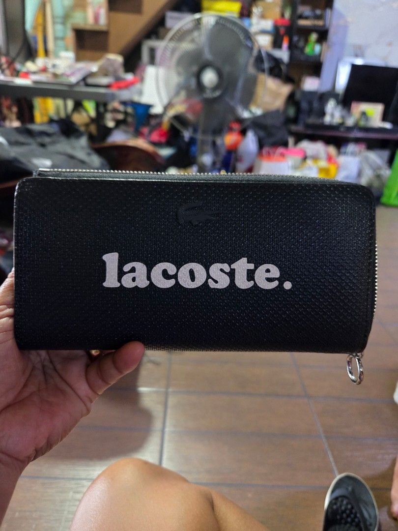 Lacoste Black Zip Around Wallet (Category: Wallets & Card holders) located in Manila. Submitted by analiepagl91301 (Listing ID 1425249833, Image 1). Description: brand new lacoste limited edition.nakalimutan ng gamitin nakatago lang.10k ang bili sa moa.