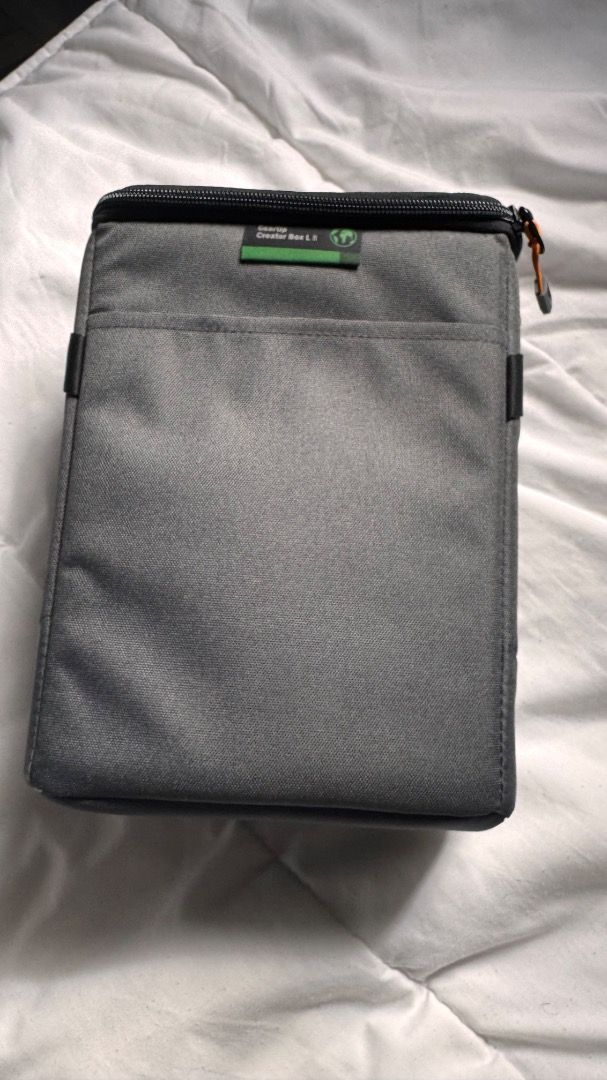 Lowepro QuickDoor 2.5 Camera Bag (Category: Camera Bags & Carriers) located in Antipolo. Submitted by littlefoot15p (Listing ID 1425315868, Image 2). Description: Lowepro camera bag features a QuickDoor design for easy access. It has a gray exterior with a black strap and orange accents. The interior is bright orange with adjustable compartments. It includes a front pocket and a top handle. The bag is designed to protect camera equipment..