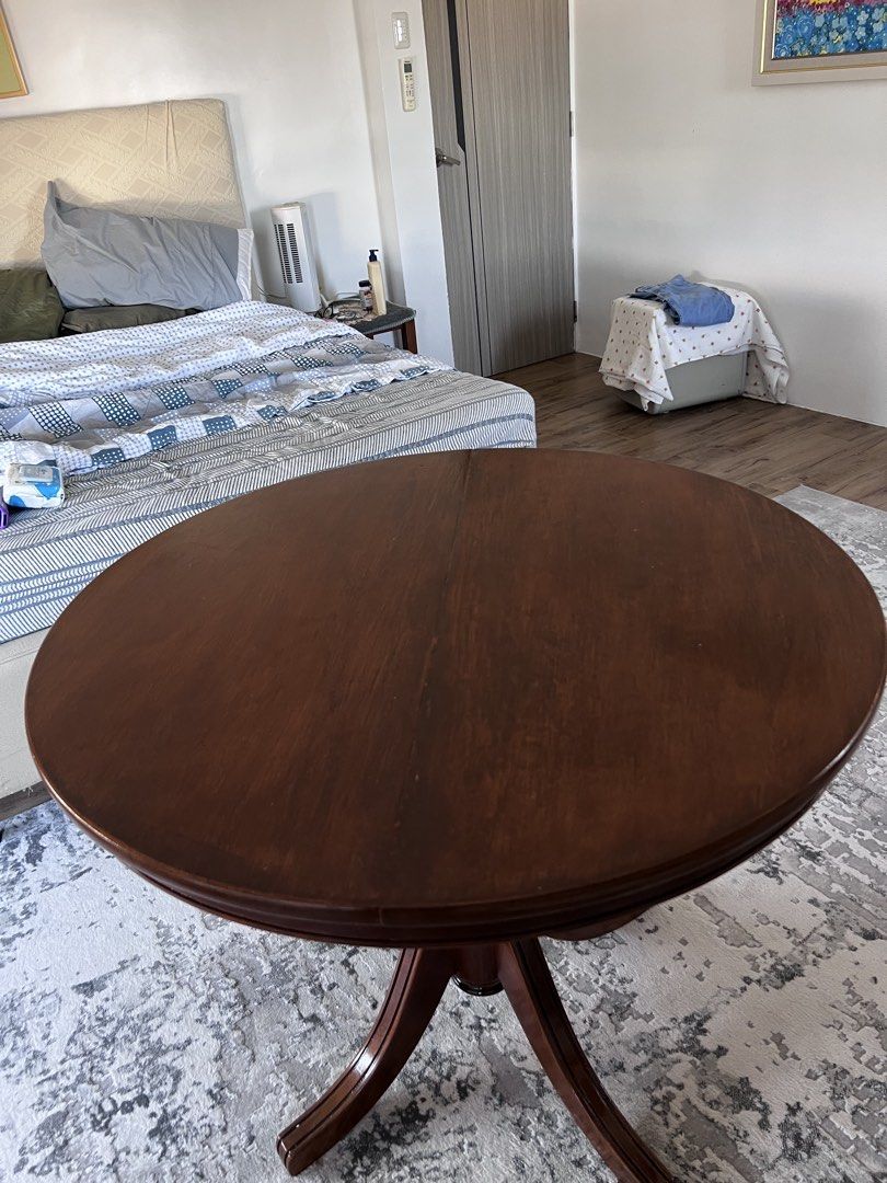 Narra Round Wooden Dining Table (Category: Tables & Sets) located in Calamba. Submitted by jonahjavier (Listing ID 1425294257, Image 1). Description: Elegant round wooden dining table. Features a rich, dark brown finish and a classic pedestal base. Perfect for small spaces or as a charming accent piece. Ideal for everyday use or special occasions..