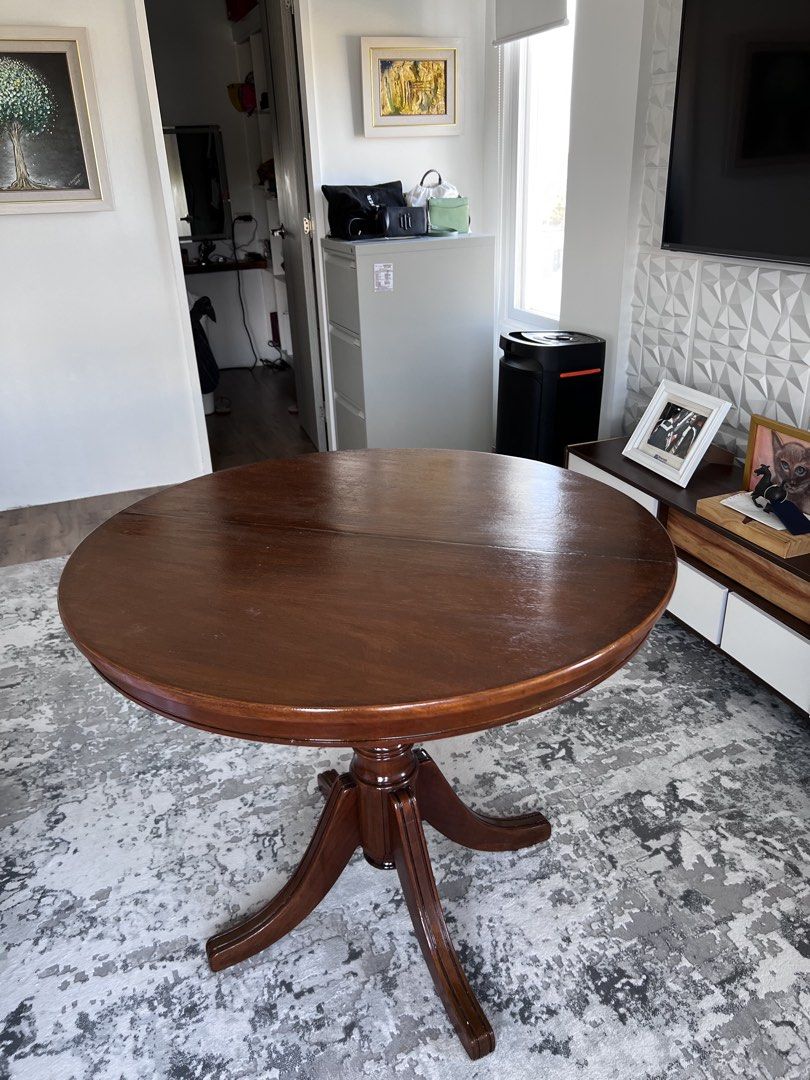 Narra Round Wooden Dining Table (Category: Tables & Sets) located in Calamba. Submitted by jonahjavier (Listing ID 1425294257, Image 3). Description: Elegant round wooden dining table. Features a rich, dark brown finish and a classic pedestal base. Perfect for small spaces or as a charming accent piece. Ideal for everyday use or special occasions..