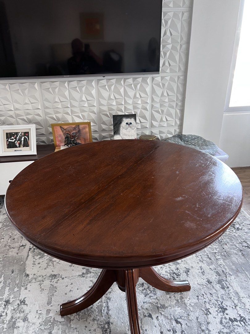 Narra Round Wooden Dining Table (Category: Tables & Sets) located in Calamba. Submitted by jonahjavier (Listing ID 1425294257, Image 2). Description: Elegant round wooden dining table. Features a rich, dark brown finish and a classic pedestal base. Perfect for small spaces or as a charming accent piece. Ideal for everyday use or special occasions..
