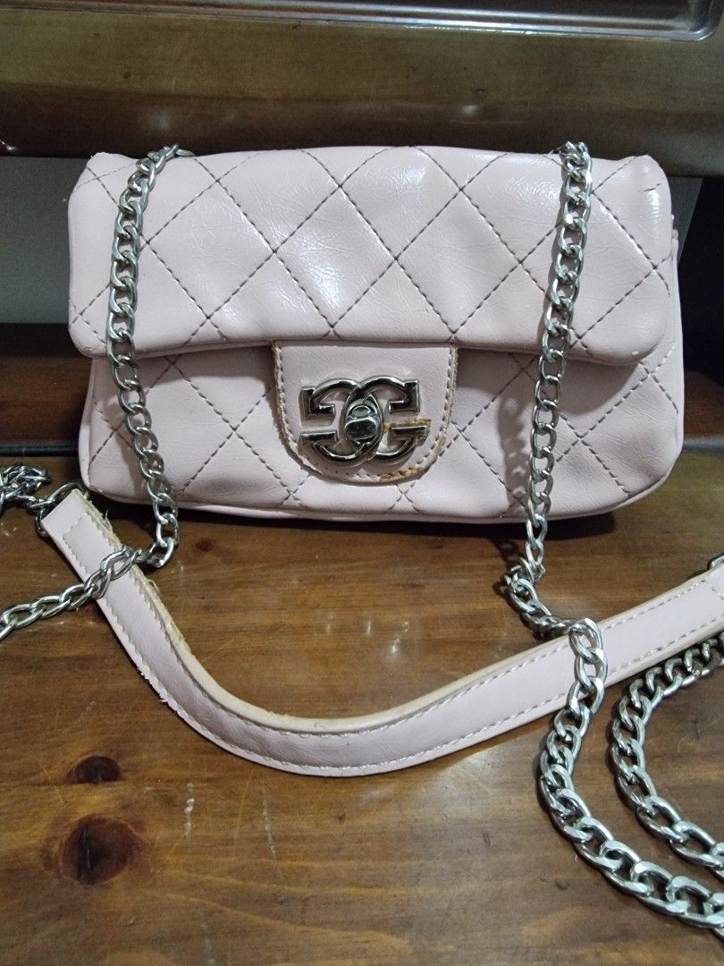 Small Pink bag with Chain Strap (Category: Luxury Bags & Wallets) located in Manila. Submitted by chuckie_052026 (Listing ID 1425280564, Image 1). Description: Pink quilted bag with a silver chain strap. Features a flap closure with a silver logo detail. The interior has a zipper pocket. The strap is a combination of chain and a pink material. The bag has a quilted design..
