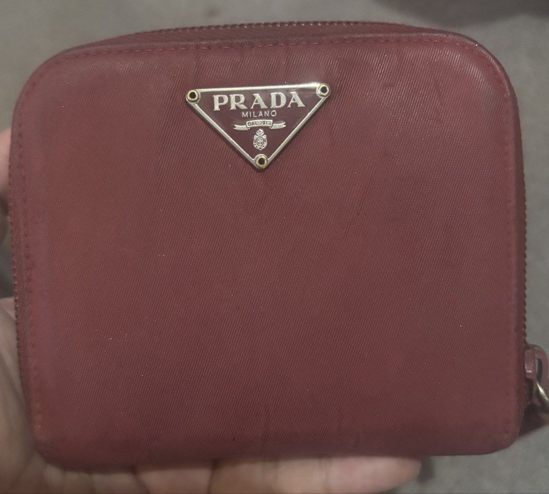 Prada Red Zip Around Wallet (Category: Luxury Bags & Wallets) located in Cavite. Submitted by tetpangan (Listing ID 1425396695, Image 1). Description: Prada nylon short wallet Red color Guaranteed authentic, bought in Japan With bills, cards and coin compartments Issue: Canvas needs cleening or best if recolor (for buyer prefers).